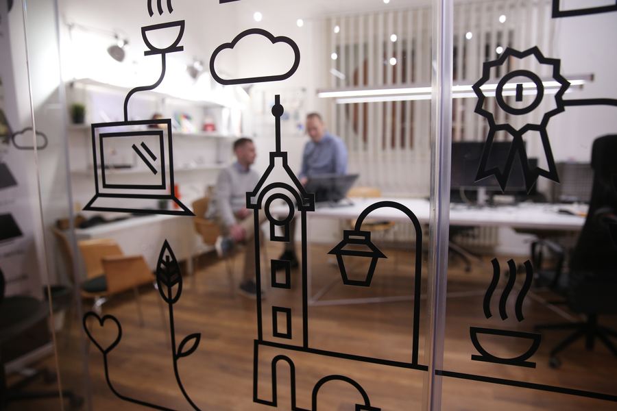 Hand-drawn illustrations on the glass walls of our office
